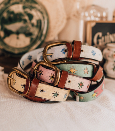 Stack of finished charm belts on a tabletop